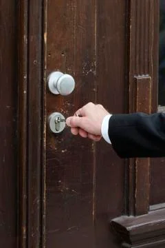Closeup of hand with key at a door Stock Photos