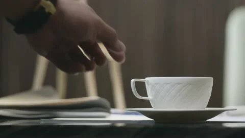 Closeup of hand lifting up a cup of coffee indoors Stock Footage 160943708