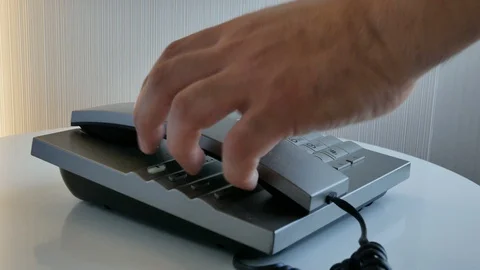 Closeup hand making a call composing numbers on keyboard telephone or phone inte Video stock 112021166