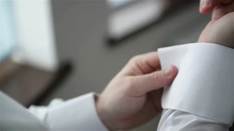 Closeup of a hand man how wears shirt and cufflink, man dressed in the wedding Stock Footage 63513922