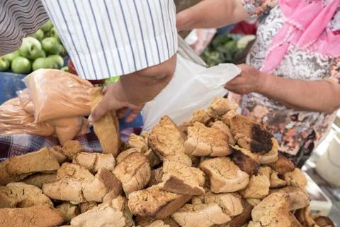 Closeup hand of a man picking bread at market Stock Photos