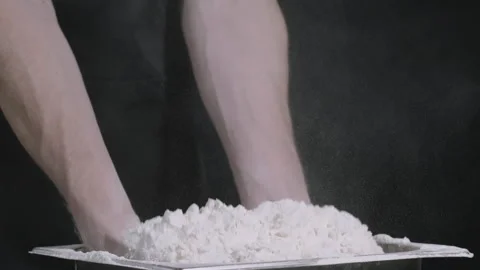 Closeup of the hand of a man taking wheat flour on a black background in slow Stock Footage 264768910