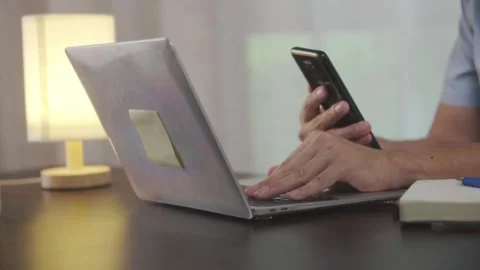 Closeup hand man using phone take pictures in Laptop ,Email concept. 動画素材 244799228