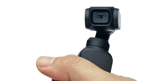 Closeup hand manoeuvring and control little ccompact amera with gimbal on white  Stock Footage 122974459