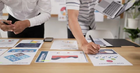 Closeup of hand men checking to task on workplace desk while standing in office Stock Footage 201914615