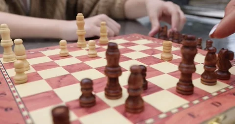 Closeup of hand moving chess piece playing on checkered board Stock Footage 292867912