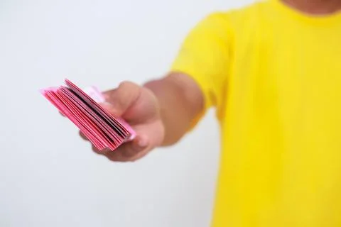 Closeup Of A Hand Offering A Stack Of Local Currency Banknotes Foto stock