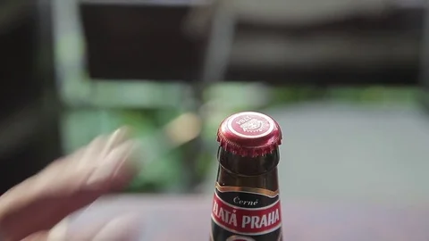 Closeup of the hand opens a bottle of beer in an unusual way Video stock 71943837