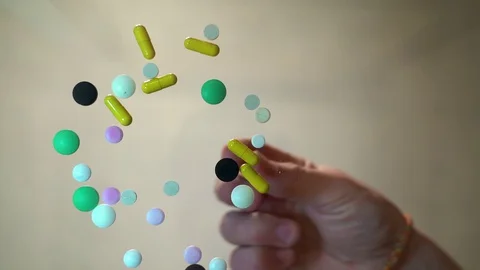 The closeup hand picks up the pills, bottom view. drugs and medicines Stock Footage 128451025