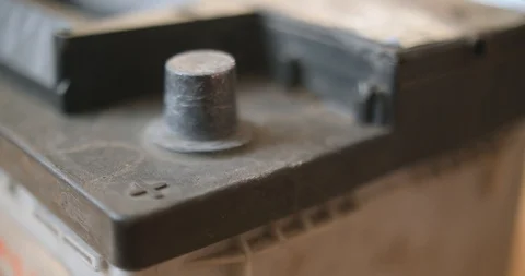 Closeup of hand plug car automobile battery charger red clamp on accumulator Stock Footage 88730892