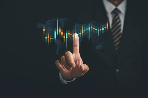 Closeup hand with pointing finger analyzing stock market graph 스톡 사진