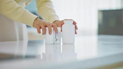 Closeup of Hand Pouring Supplement Capsules from Bottle 스톡 동영상 339132670