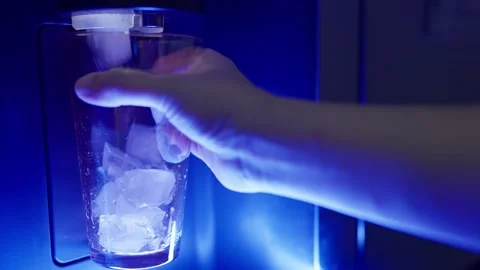 Closeup hand pressing the button on an automatic ice dispenser in a refrigerator Stock Footage 297248941