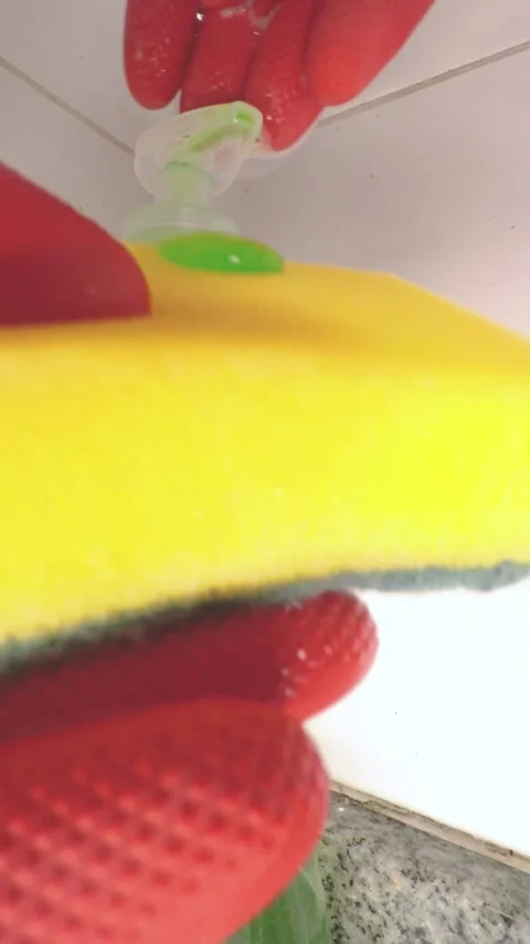Closeup of a hand with red gloves putting avocado soap on a sponge Stock Footage 278954552