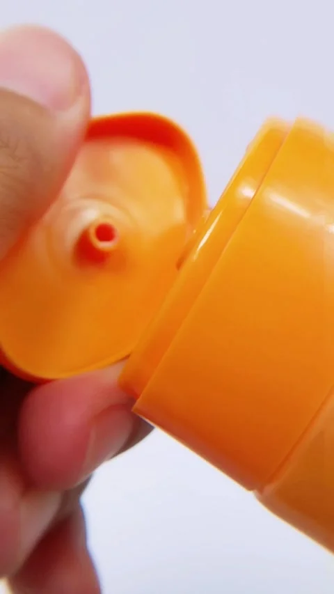 Closeup of hand removing cap from cosmetic cream tube. Vertical footage Stock Footage 335388339