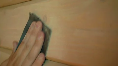 Closeup of a hand sanding wood using sandpaper. Video stock 162447469