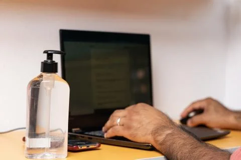 Closeup of hand sanitizer while suing computer Stock Photos