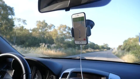 Closeup hand searching and navigating on phone while driving Stock Footage 112123122