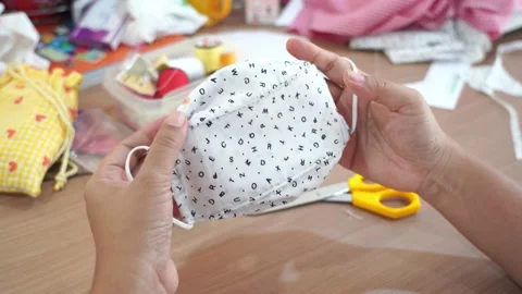 Closeup hand sewing and making DIY or handmade protective mask Stock-Footage 137498879