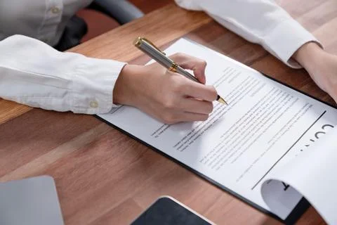 Closeup hand signing contract document with pen. Enthusiastic. Stock Photos
