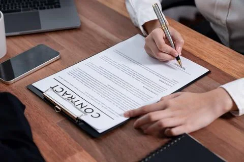 Closeup hand signing contract document with pen. Enthusiastic. Stock Photos