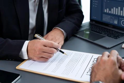 Closeup hand signing contract document with pen. Fervent. Stock Photos