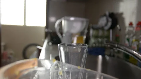 Closeup of a hand squeezing an orange with a juicer Видео 89478263