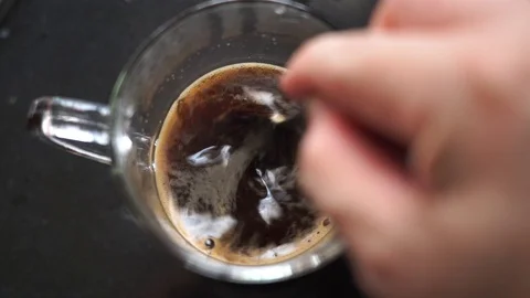 Closeup hand stir hot coffee, Drinking and relax concept, Slow motion Stock Footage 129549088