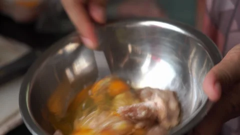 Closeup hand stirring egg mixing with pork preparing for omelet Stock Footage 130048507