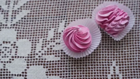 Closeup hand takes two pink marshmallow cookies from small group served on table Stock Footage 217481445