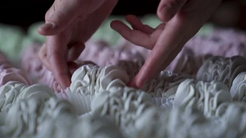Closeup hand takes two white marshmallow cookies from big group served on table. Stock Footage 221017885