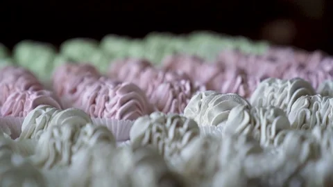 Closeup hand takes two white marshmallow cookies from big group served on table. Stock Footage 221628093