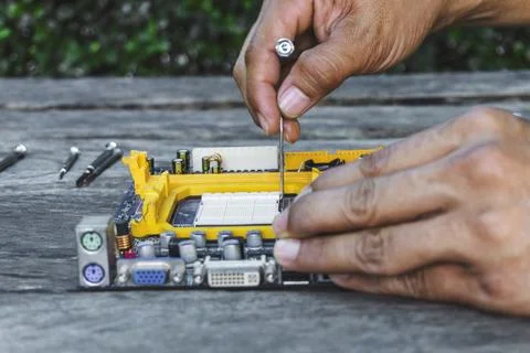 Closeup hand of technician open socket lock CPU or Central Processing Unit .. Stock Photos