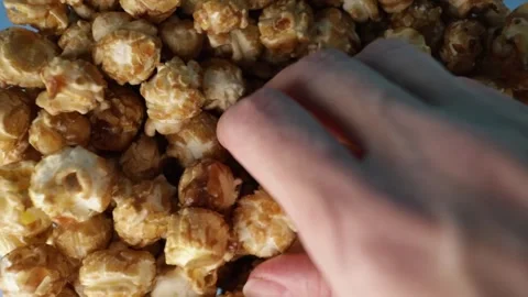 Closeup of Hand Touching Popcorn, Crunchy Snack Scene Stock Footage 306530177