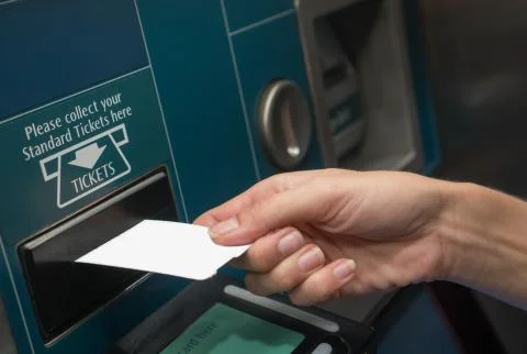 Closeup hand with train ticket from self service machine Stock Photos