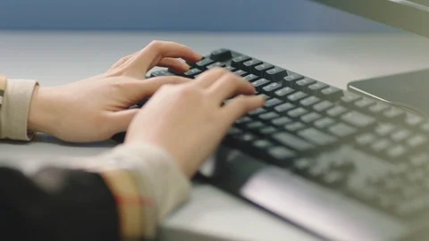 Closeup of hand typing on computer keyboard in office Stock Footage 123784365