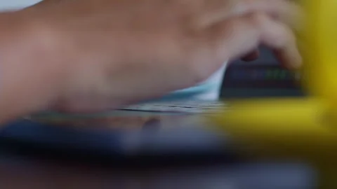 Closeup of a hand typing on a keyboard, with fingernails visible 库存影片 267185019