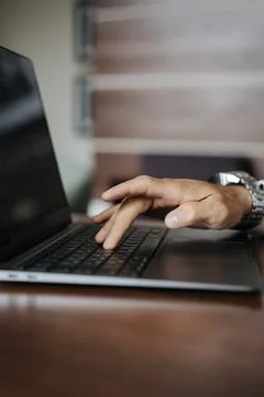 Closeup of a hand typing text on a laptop Stock Photos