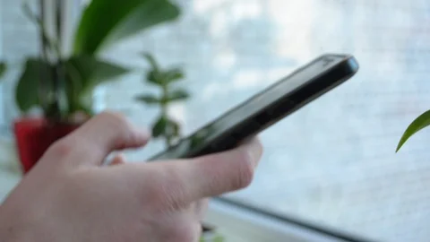 Closeup hand unlocking and holding a smartphone on blurred background 스톡 동영상 89181558