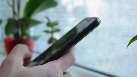 Closeup hand unlocking and holding a smartphone on blurred background 스톡 동영상 89181562