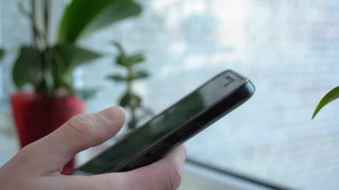 Closeup hand unlocking and holding a smartphone on blurred background 스톡 동영상 89181572
