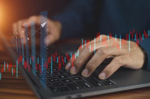 Closeup hand using computer trading online on digital chart visual screen tec Stock Photos