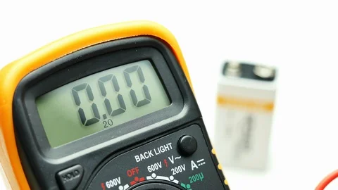 Closeup hand using digital multimeter to measure level of charge of a battery Stock Footage 128812740