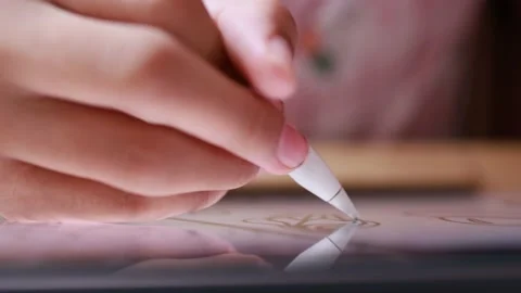 Closeup hand using digital pen drawing sketching on digital tablet Stock Footage 180981023