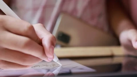 Closeup hand using digital pen drawing sketching on digital tablet Stock Footage 180981514