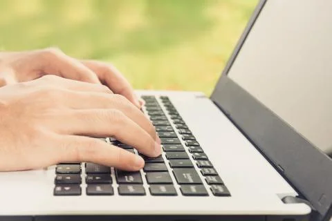 Closeup hand using laptop computer outdoor Stock Photos