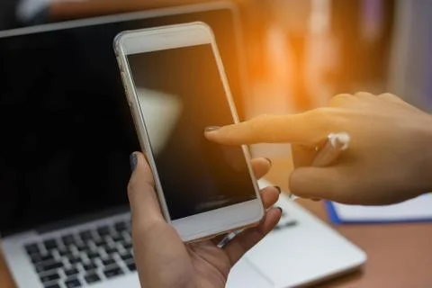 Closeup of hand using smartphone with effects Stock Photos