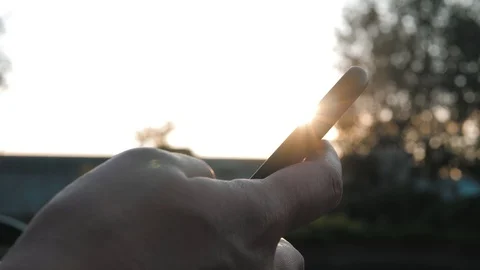 Closeup Of Hand Using Smartphone On Sunset Background Stock Footage 119056923