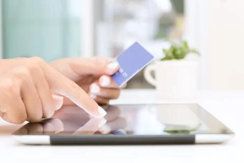 Closeup hand using tablet and credit card shopping online Stock Photos