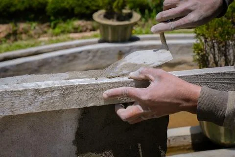 Closeup hand of worker plastering cement Stock Photos
